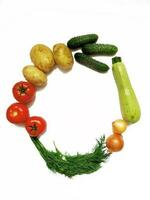 vegetables are laid in the shape of a circle on a white background, space for text photo