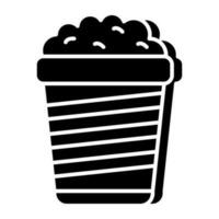 A solid design icon of popcorn bucket vector