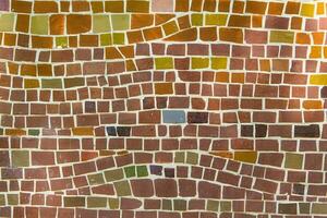 Colorful ceramic mosaic on the walls of the building. Abstract background and texture for design. photo