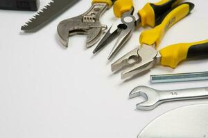 Set of tools for repair in a case on a white background. Assorted work or construction tools. Wrenches, Pliers, screwdriver. Top view photo