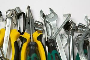 Set of tools for repair in a case on a white background. Assorted work or construction tools. Wrenches, Pliers, screwdriver. Top view photo