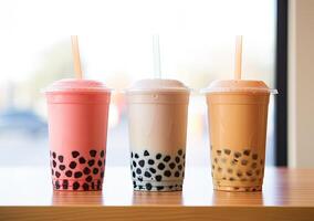illustration of product photo of 3 plastic cups of boba milk tea, with bubbles, fun, solid soft pastel background