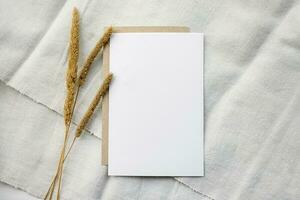 Fashionable stock stationery background - a white map and sprigs of wheat ears on a white table. Romantic background. Blank for an invitation card. photo