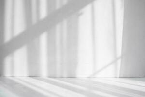 Abstract white background. Shadows on a white table and a white wall photo