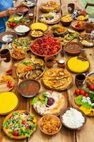 Homemade Romanian Food with grilled meat, polenta and vegetables Platter on camping. Romantic traditional moldavian food outside on the wood table. photo