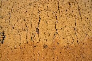 Soil wall texture of old clay house structure. One kind of material make house wall in North Vietnam photo