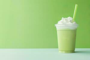 Green tea frappucino with whipped cream in a takeaway cup isolated on green background with copy space. ai generated photo