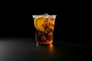 Iced lemon tea on plastic takeaway glass isolated on dark background. ai generated photo