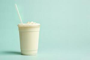 Vanilla milkshake in plastic takeaway cup isolated on pastel background with copy space. ai generated photo