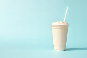 Vanilla milkshake in plastic takeaway cup isolated on pastel background with copy space. photo