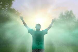 Happy young man standing in a natural sunrise with raising arms. ai generated photo