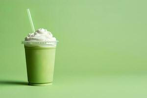 Green tea frappucino with whipped cream in a takeaway cup isolated on green background with copy space. ai generated photo