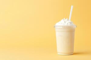 Vanilla milkshake in plastic takeaway cup isolated on pastel background with copy space. photo