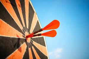 red darts arrows in the target center on blue sky background. Business target and success concept. ai generated photo