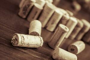 Wine corks on wooden table background photo