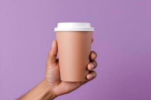 Generative AI illustration of paper coffee cup in a hand, isolated purple background photo