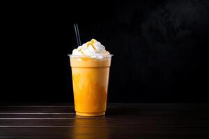 Mango smoothie milkshake in plastic takeaway cup isolated on dark background. photo