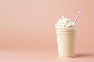 Vanilla milkshake in plastic takeaway cup isolated on pastel background with copy space. photo