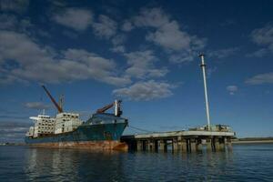 Merchant ship moored in the Port of San Antonio Este, Rio Nagro Province, Patagonia, Argentina. photo