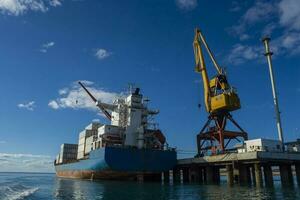 Merchant ship moored in the Port of San Antonio Este, Rio Nagro Province, Patagonia, Argentina. photo