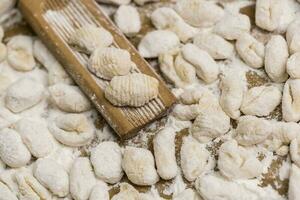 Cook homemade gnocchi on the table, Italian tradition photo