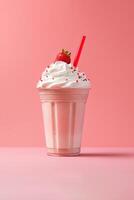Strawberry milkshake in plastic takeaway cup isolated on pink background. photo