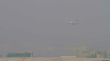 HONG KONG NOVEMBER 10, 2019 - Long shot of Airbus A380 approaching over the Hong Kong city in the haze before landing. Largest civil airplane arrives to Hong Kong airport video