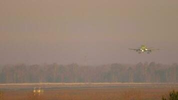 Passenger plane silhouette move from above, down to ground. Nice desert like dusk sky video
