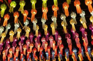 colorful hanging lanterns lighting on night sky in loy krathong festival at northern of thailand photo