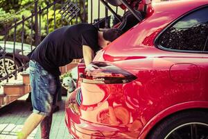 Men Cleaning Car Trunk photo