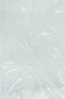 Vertical transparant wrinkled plastic, white plastic or polyethylene bag texture, macro, white background photo