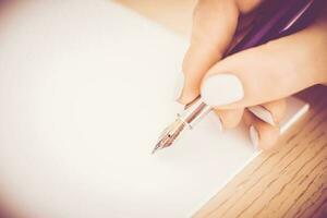 Close up of a woman hand writing photo