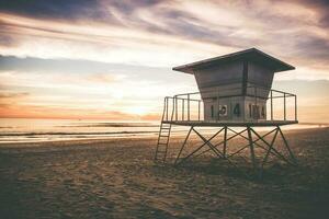 Lifeguard Tower at sunset near Ocean photo