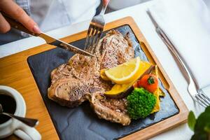 T-bone steak in fancy restaurant on plate. photo