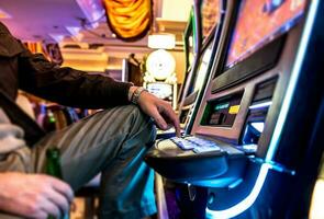 Gambler and Slot Machine photo