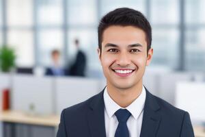 Young smart businessman, standing in blur background of office. photo