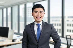 Young smart businessman, standing in blur background of office. photo