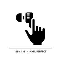 Hand with earphone pixel perfect black glyph icon. Finger tapping key on audio device. Gadget for music listening. Silhouette symbol on white space. Solid pictogram. Vector isolated illustration