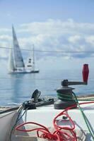 Sailing - Close-up of Winch with Sailboat in Background photo