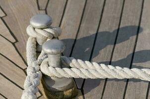 Moored boat - Ropes Fasten to Cleat photo