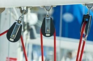 Sailboat Detail - Three Sailing Pulleys with Red Rope photo