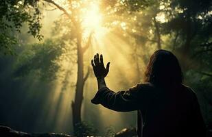 Man praying in the forest photo