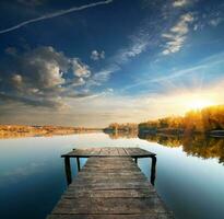 Pier on a calm river photo