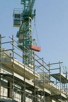 Contruction Site with Scaffolding and Crane photo