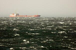 Cargo Ship in a Stormy Rough Sea photo