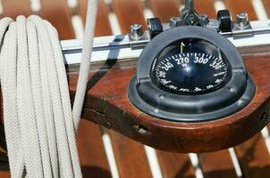 Close-up of Compass on Boat Deck photo