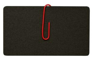 Black paper cardboard business card and red metal paper clip on a white background photo