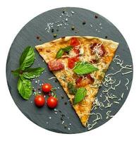 Delicious triangular slice of pizza with smoked sausages, mushrooms, tomatoes photo