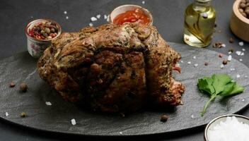 Baked pork collar with spices on a wooden board, delicious and juicy meat photo