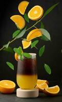 Iced coffee with orange juice in a transparent glass, refreshing bumble coffee on the table photo